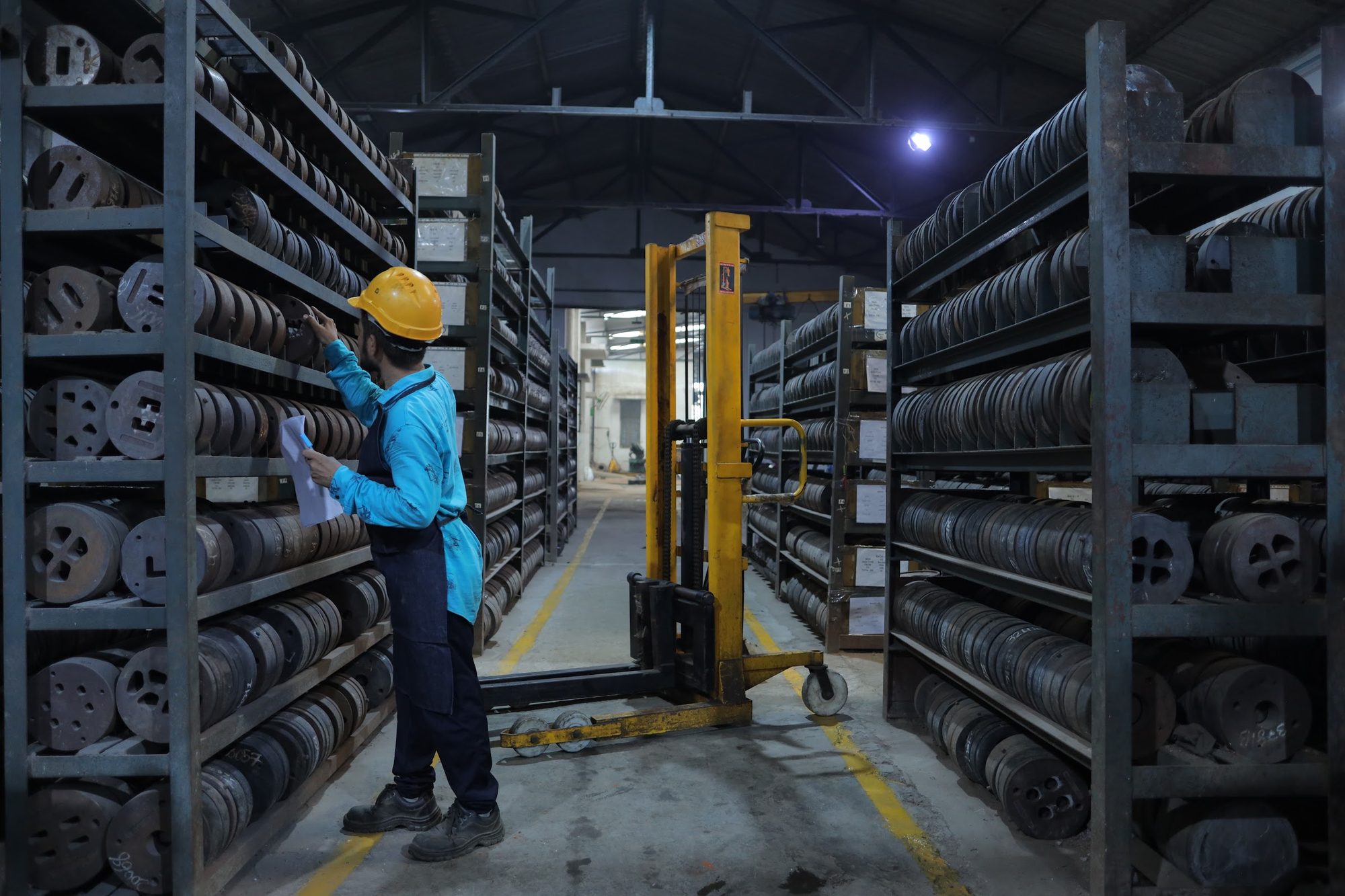 Banco Aluminium die-shop technician checking extrusion dies in the die store